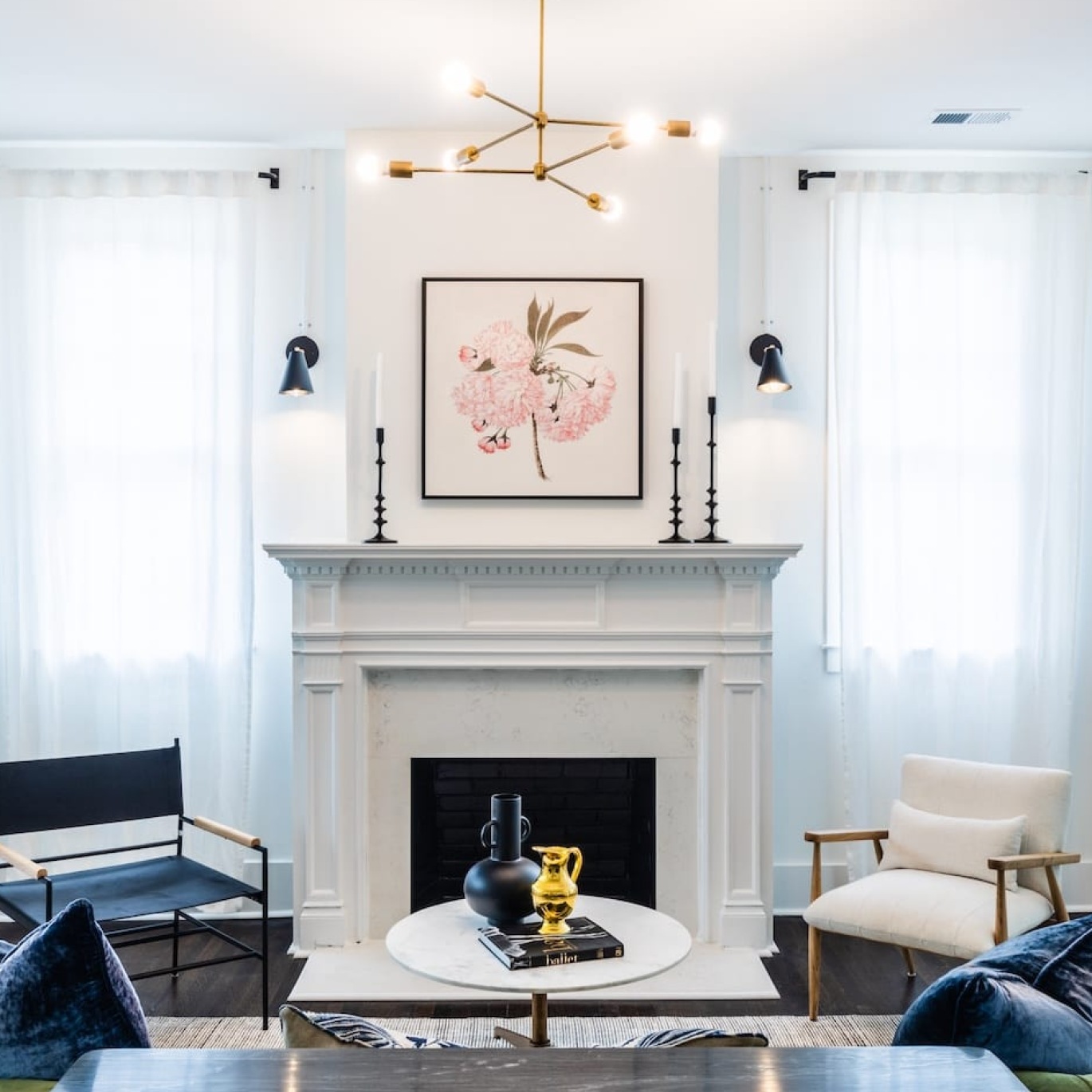 a bright lounge area with seating and a fireplace