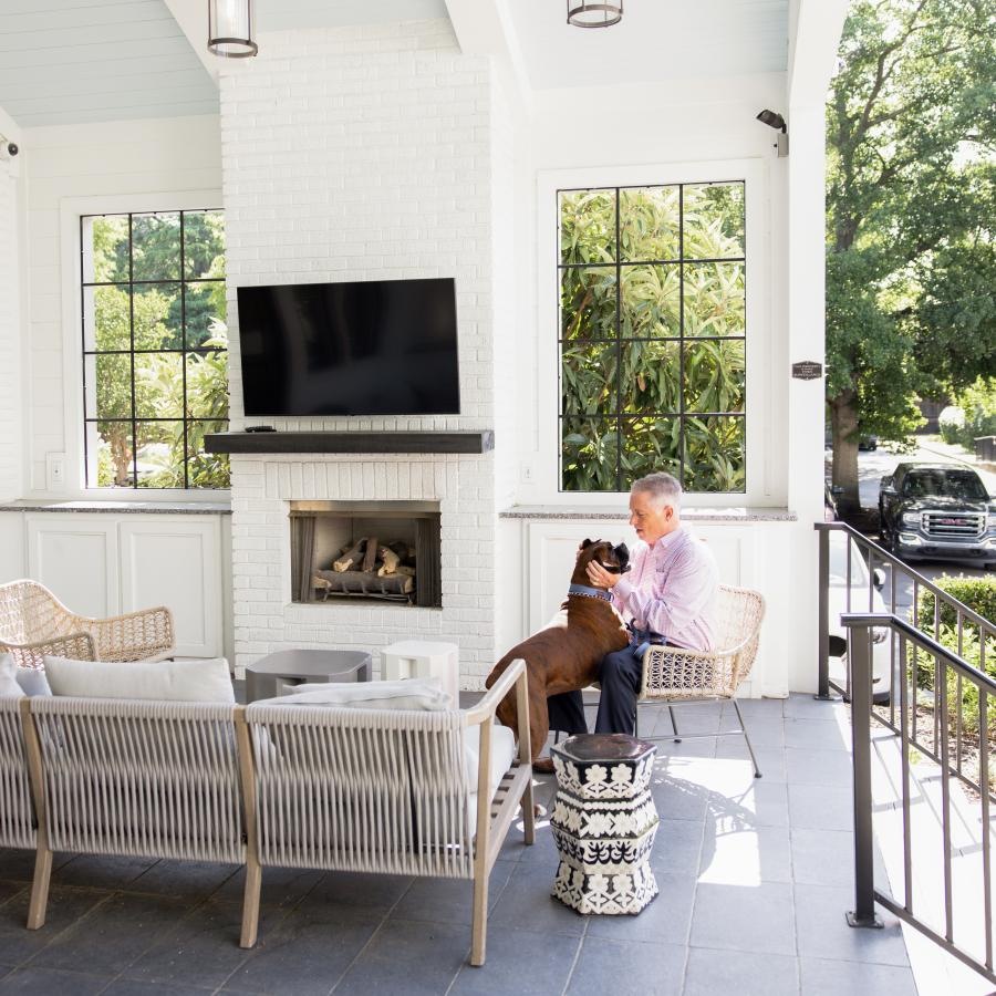 a man and a dog sitting in a bright lounge area